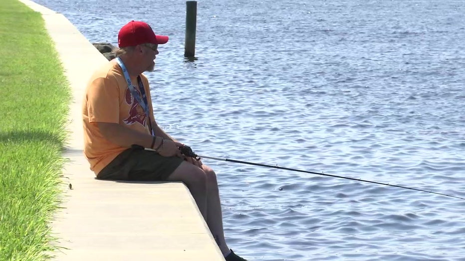Man fishing off wall in Palmetto as Tropical Depression 9 forms. 