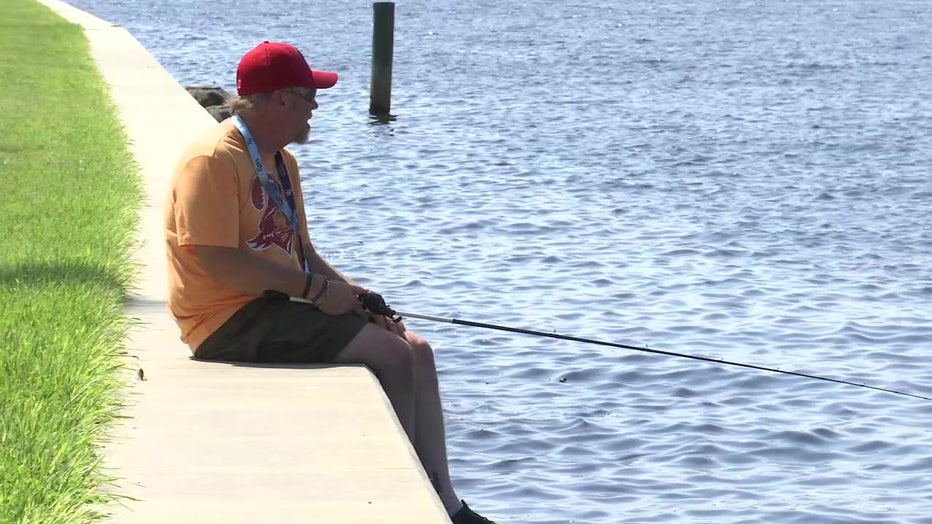 Man fishing off wall in Palmetto as Tropical Depression 9 forms.