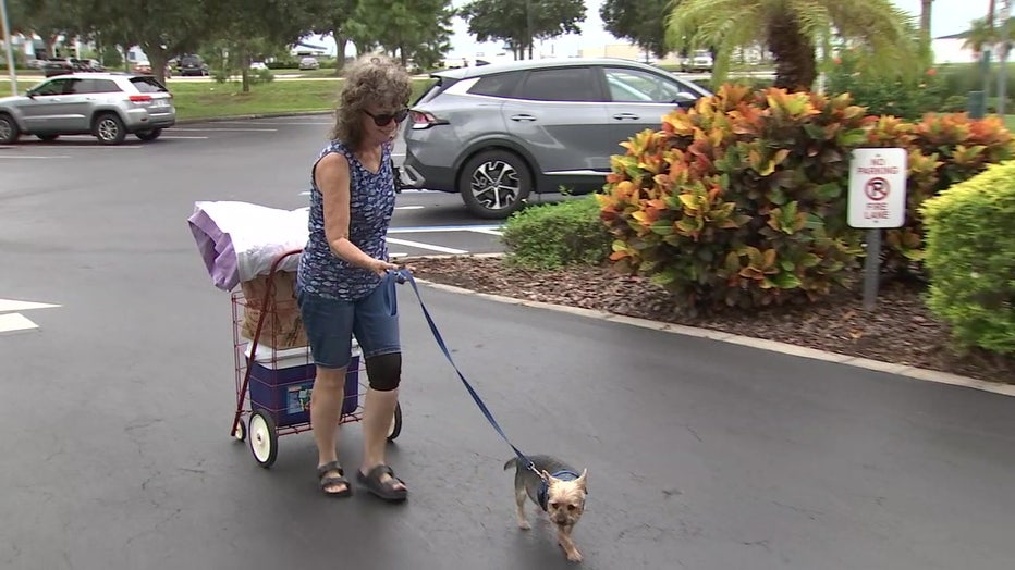 On Tuesday, as Hurricane Ian got closer to the Tampa Bay area, Gini Roberts and her dog Harry checked in at the Hilton Garden Inn. 