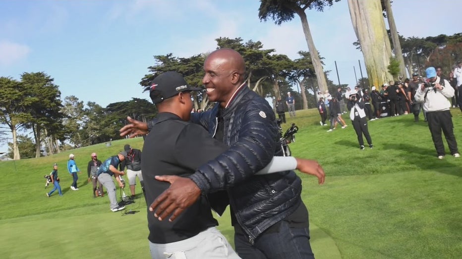 Sarasota teen hugs another athlete on golf course during the Underrated Golf Tournament. 