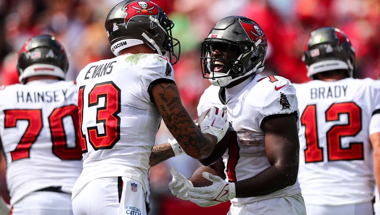 Leonard Fournette #7 of the Tampa Bay Buccaneers celebrates with Mike Evans #13 after scoring a touchdown during the second quarter of the game against the Atlanta Falcons at Raymond James Stadium on October 9, 2022 in Tampa, Florida.