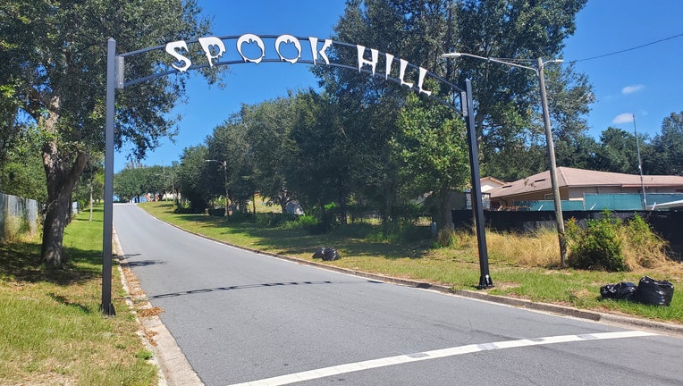 An archway over Fifth Street in Lake Wales depicts Spook Hill where cars appear to roll backward uphill. 