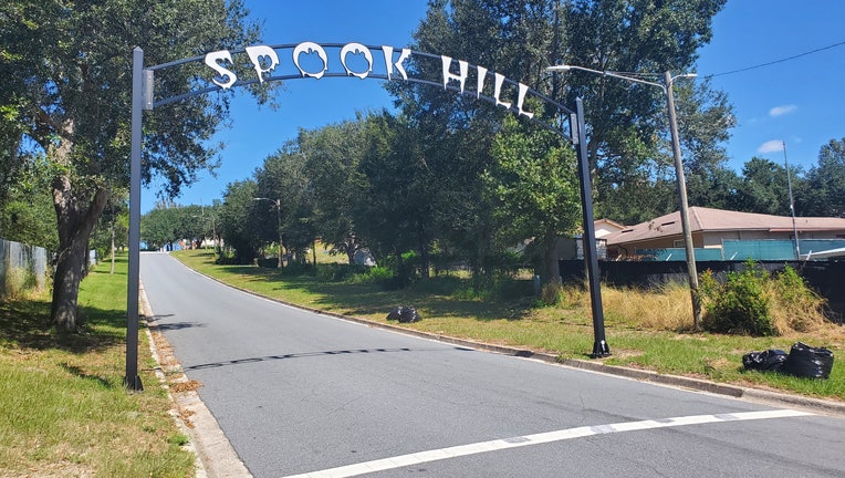 An archway over Fifth Street in Lake Wales depicts Spook Hill where cars appear to roll backward uphill.