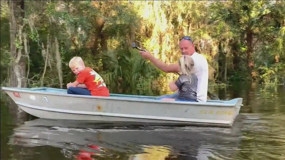 Residents near Alafia River use boats to travel flooded roadways