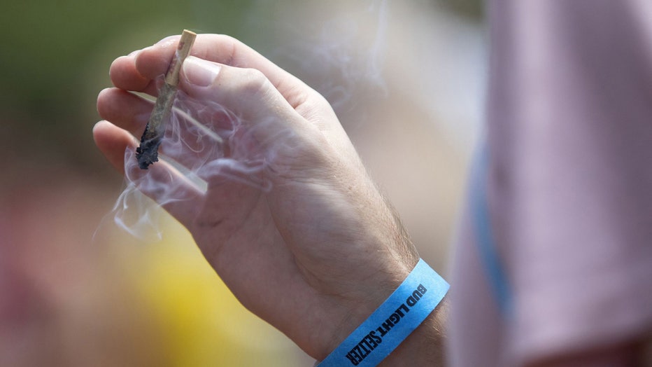 Hand holding a marijuana joint