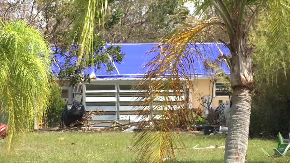 Blue tarp rests on top of a North Port home after Hurricane Ian.