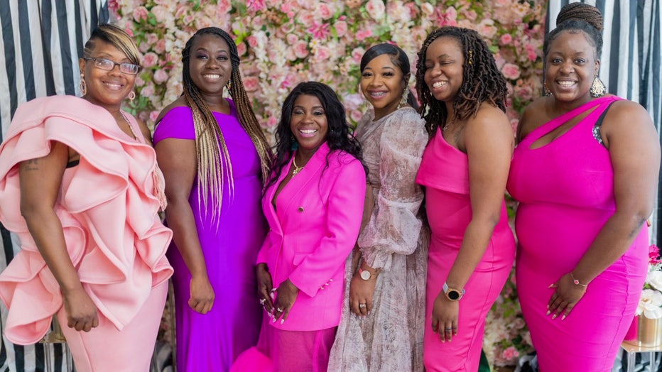 Tiana Marshall and women posing for photo at event.