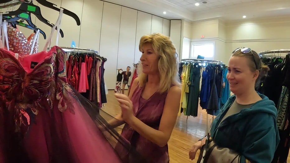 Stephanie Brown and a mother looks at dresses during Gowns for Girls event. 