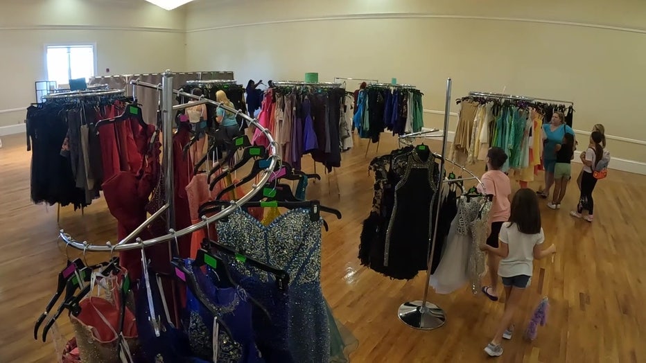 Dresses on racks at Gowns for Girls event. 