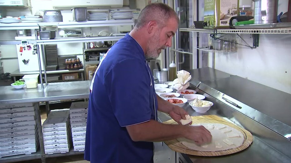 Jamie Culliton is making his award-winning pizza. 