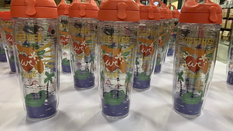 Tumblers with the phrase "Together We Shine" show images of Florida life.