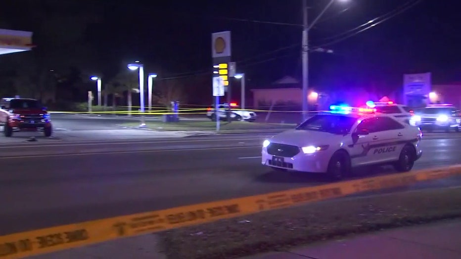 A police car near police tape. 