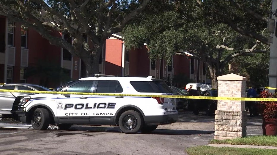 Police vehicle next to crime scene tape. 