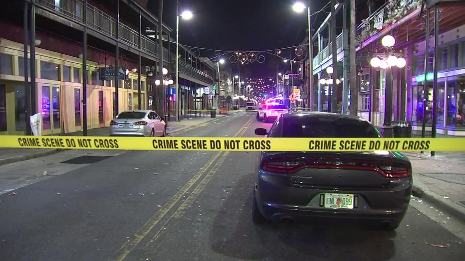 Crime scene tape and a police car in Ybor City following a shooting.