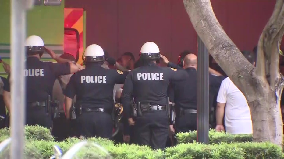 Photo: Customs and Border Protection officers along with other law enforcement officers throughout South Florida salute to honor fallen officer Jorge Arias as his body was brought to the Medical Examiner's Office. 