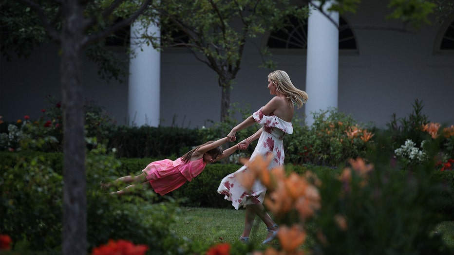 Ivanka Trump plays with her daughter Arabella Rose Kushner in the Rose Garden