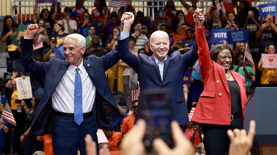 President Joe Biden stands with Democratic U.S. Senate candidate, Rep. Val Demings (D-FL) and gubernatorial candidate Charlie Crist during a rally at Florida Memorial University.