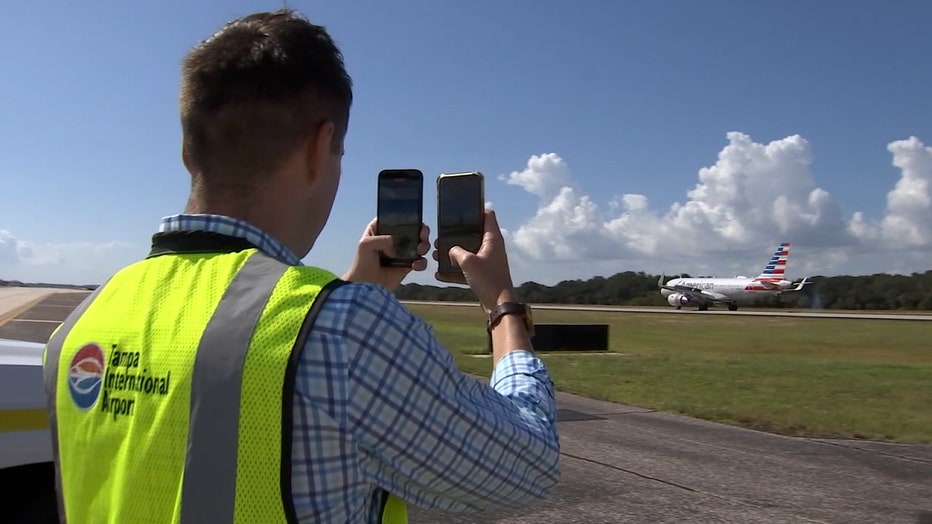 Photo: C.J. is seen shooting video of a plane taking off the runway.
