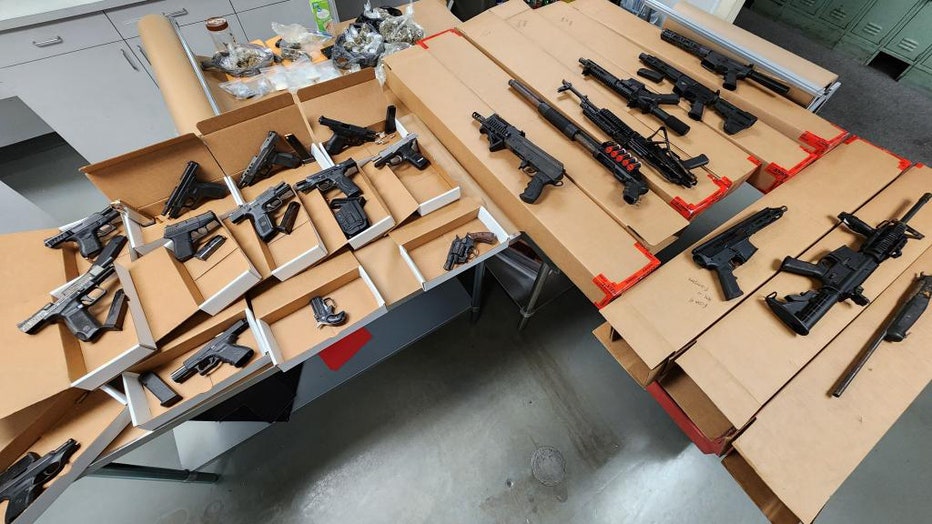 Tampa police seized 23 guns, many that were reported stolen, while investigating a suspected drug dealer. Photo is courtesy of the Tampa Police Department. 