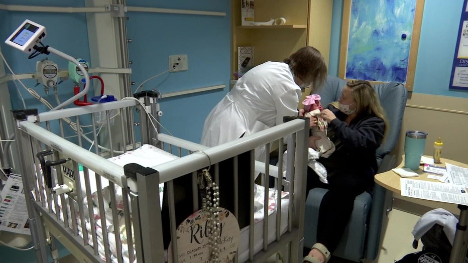 Riley with her mother and nurse in the NICU.