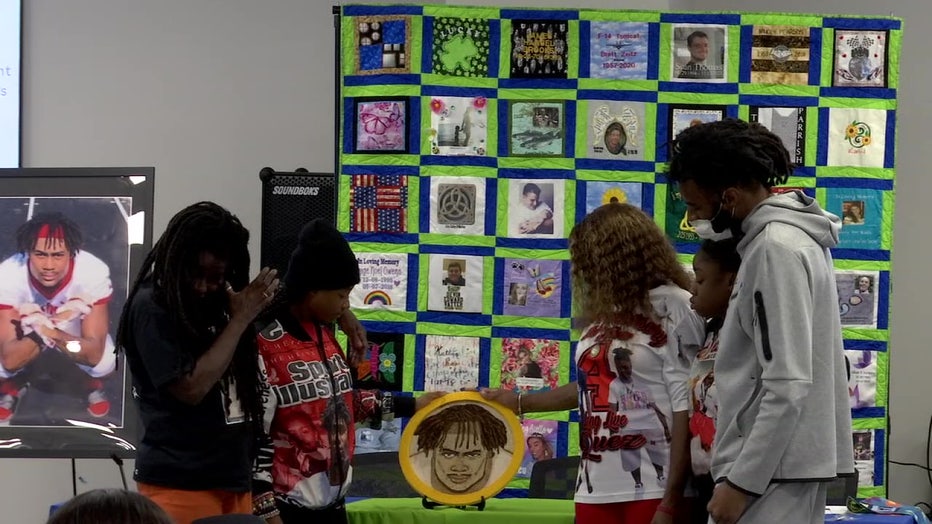 Jaquez Welch’s family put the finishing touches on a floral portrait of the 18-year-old at Bayfront Health Wednesday.