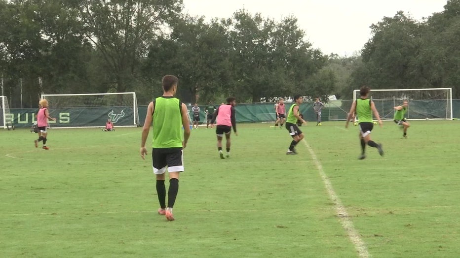 USF Bulls men's soccer team on the field. 