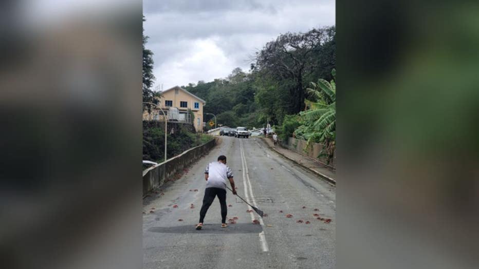 A member of the public racks away thousands of red crabs off a road on November 6, 2021 in Christmas Island.