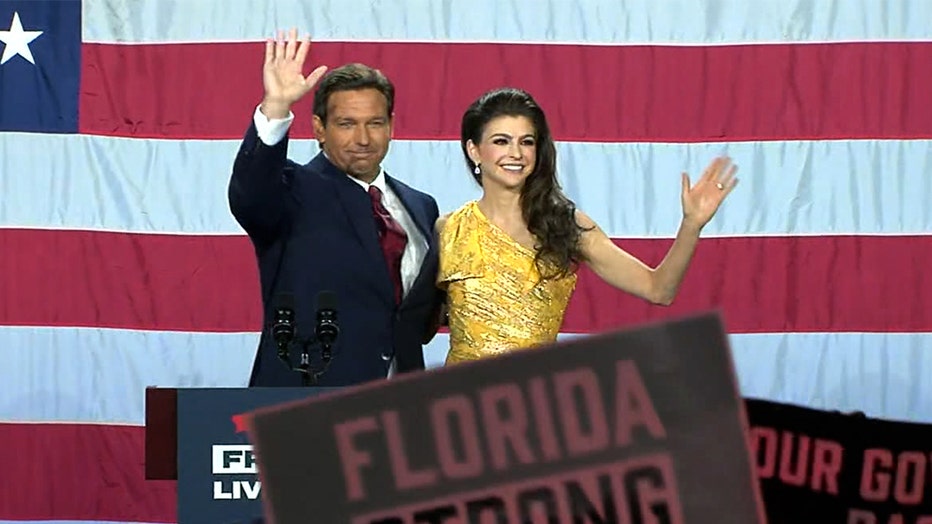 Gov. DeSantis and Casey DeSantis wave to the crowd of supporters inside the Tampa Convention Center following his victory speech.