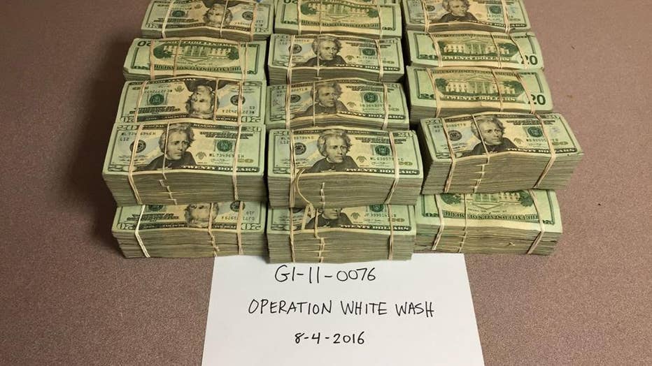 This photo provided to the AP by the U.S. Drug Enforcement Administration shows U.S. currency confiscated in "Operation White Wash" in 2016.