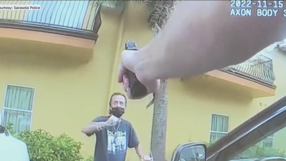 A Sarasota police officer shot an armed man accused of trying to rob a woman at knife-point in a Publix parking lot.