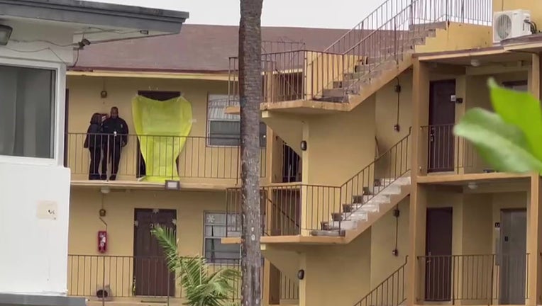 A crime scene tarp covers the front door of the apartment where a 3-year-old girl was stabbed to death by her mother, North Miami Beach police said.