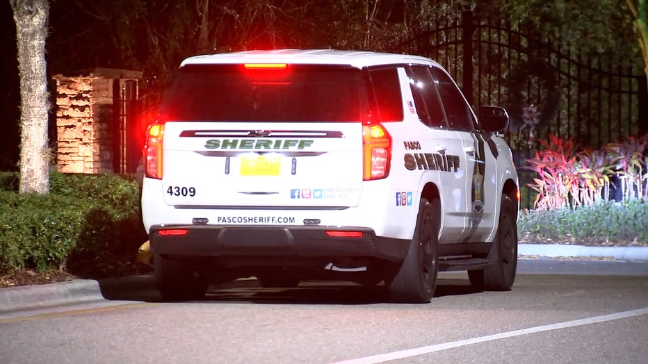 A Pasco deputy is seen entering the Marchmont community after as the agency investigates a murder-suicide, they said.