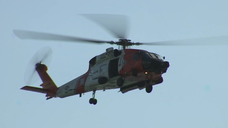 A U.S. Coast Guard chopper flies over the scene where the small plane crash occurred in Venice.