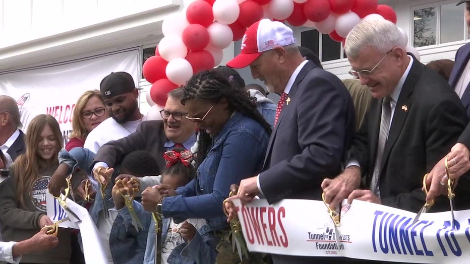 Officials with the Tunnels to Towers Foundation cut the ribbon with Danielle Thornton on her new home.