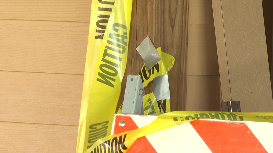 Caution tape and a barricade outside a restroom where vandals caused thousands of dollars in damage.