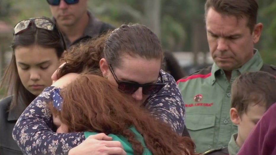 Two people hug each other during the Wreaths Across America ceremony.