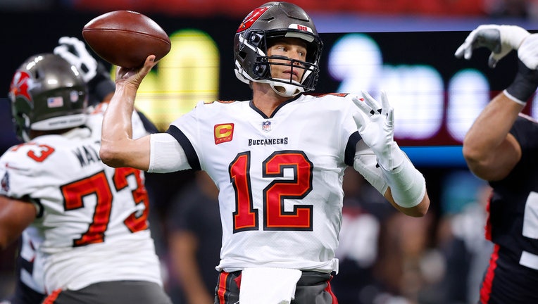 Tom Brady #12 of the Tampa Bay Buccaneers throws the ball during the first quarter against the Atlanta Falcons at Mercedes-Benz Stadium on January 08, 2023 in Atlanta, Georgia. (Photo by Todd Kirkland/Getty Images)