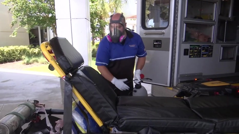 EMT cleans stretcher. 