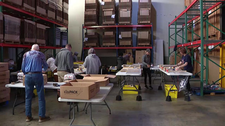 Volunteers put together packages of food for kids to eat over the weekends.