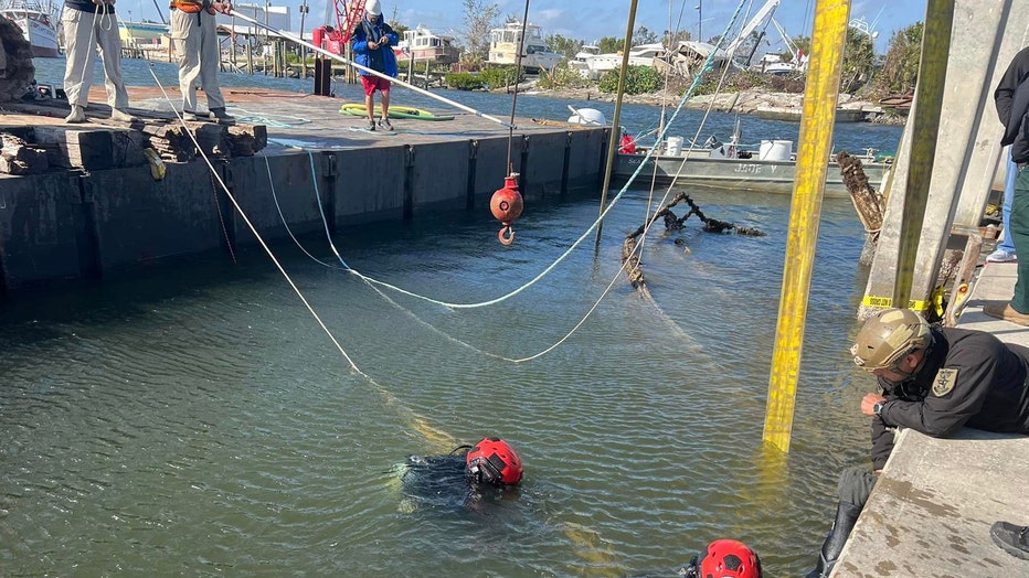 Divers in the Matanzas Pass area of Fort Myers Beach investigate the sunken sailboat "Good Girl" that belonged to 72-year-old James "Denny" Hurst.