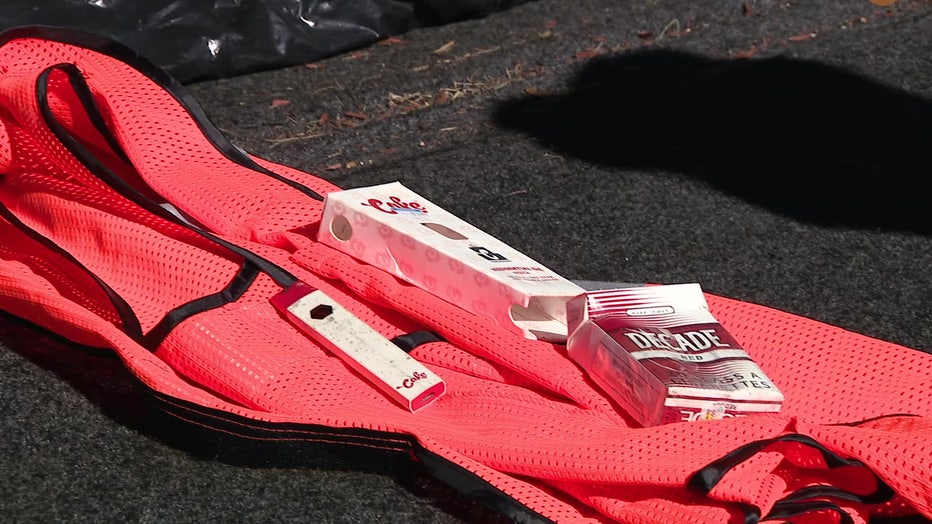 Items possibly belonging to Timothy Braddy: a construction vest in the same size he owned, and a pack of cigarettes that were the same brand he smoked.