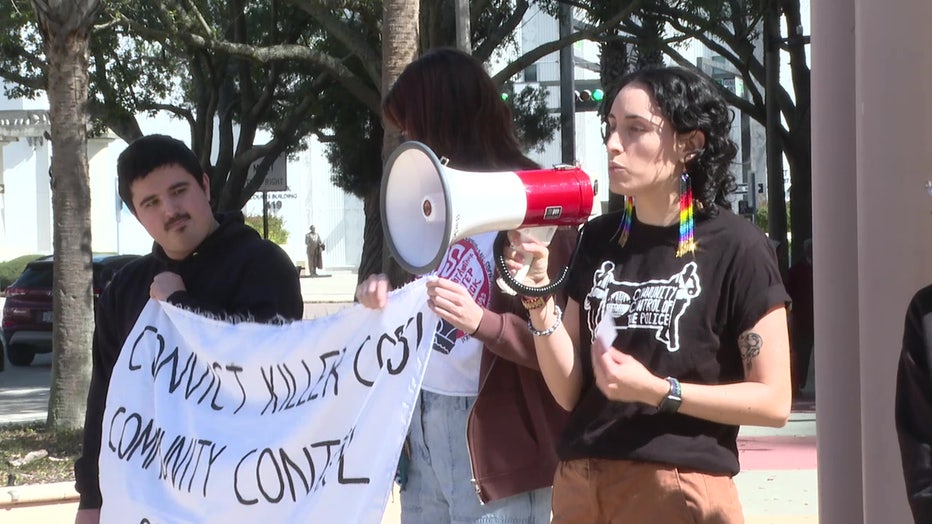 Demonstrators use a megaphone to get their message across.