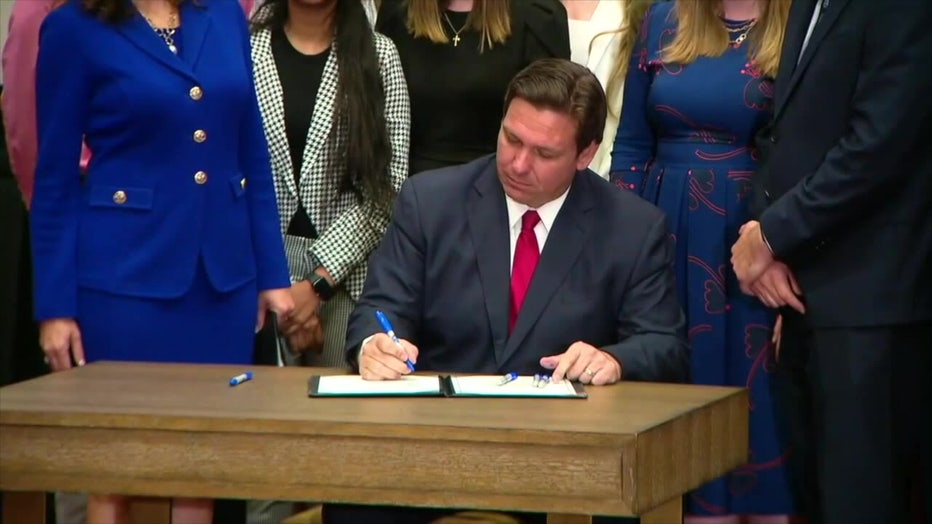 Governor Ron DeSantis signing a bill.