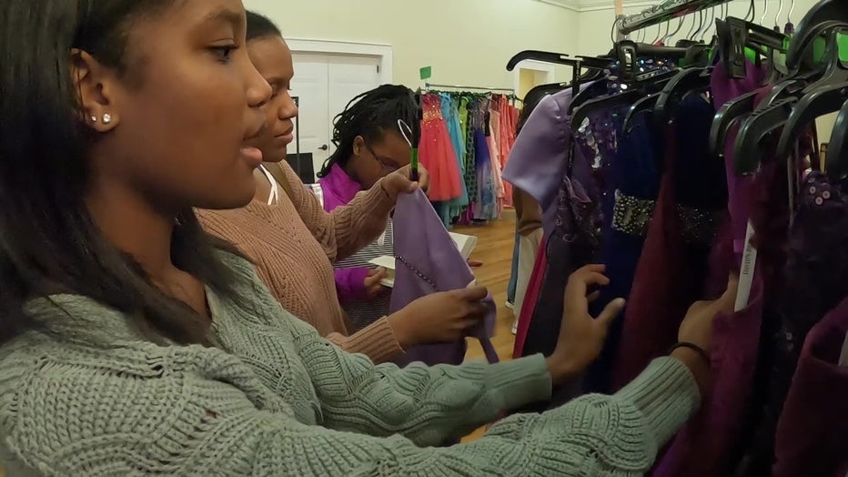 Teen searches for prom dress at Gowns for Girls. 