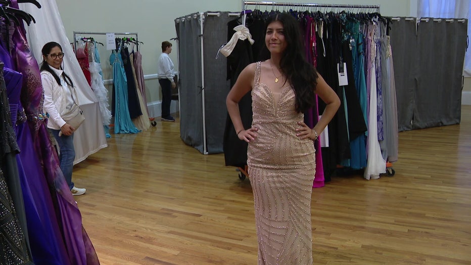 Teen tries on a dress at Gowns for Girls. 