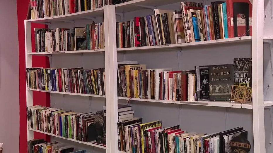 Rows of books on a shelf in a classroom. 