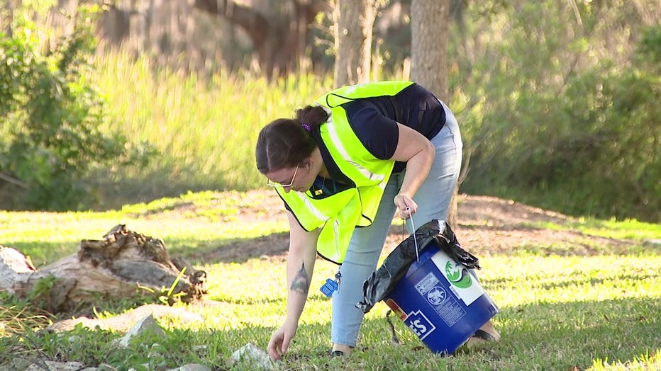 A volunteer with Keep Tampa Bay Beautiful is picking up trash. It's a non-profit that will be impacted by the end of AmazonSmile. 