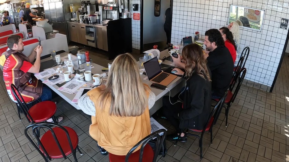 The realtors are expected to sit in the Waffle House for 24 hours. They can leave an hour early for each waffle they eat and every $100 they collect.