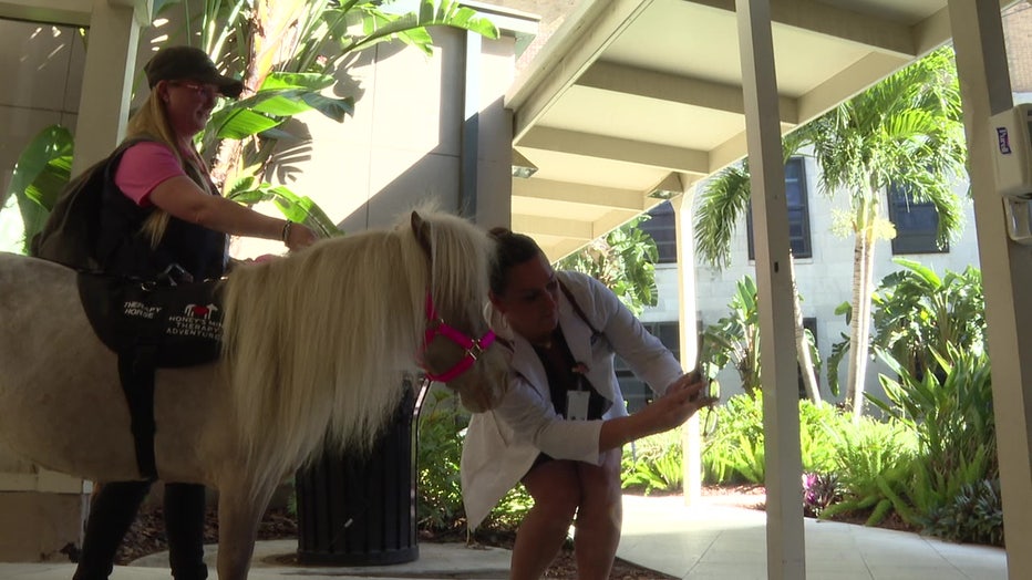 A TGH team member takes a selfie with Honey outside the hospital. 