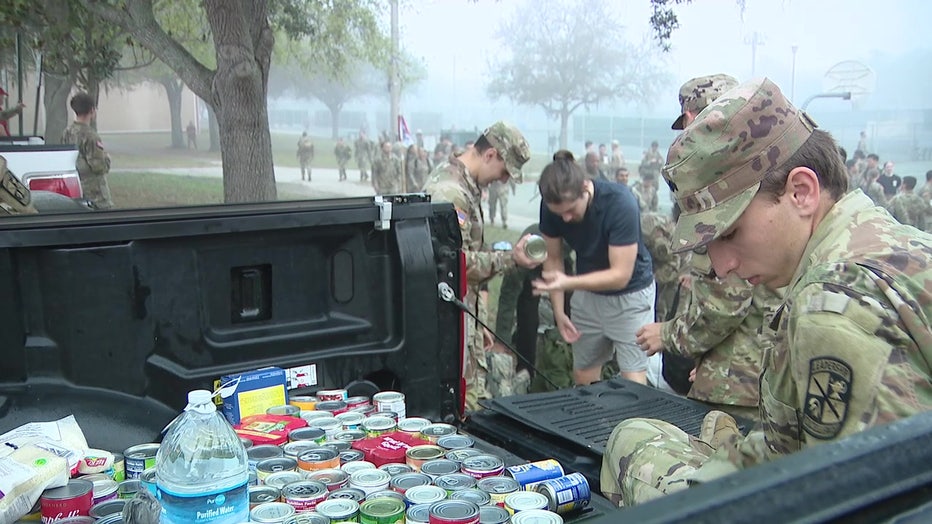 USF ROTC students pack ruck sacks full of food to take help feed the hungry. 